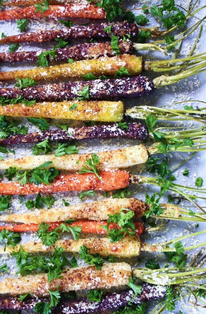 overhead shot of carrots garnished with parsley and parmesan cheese