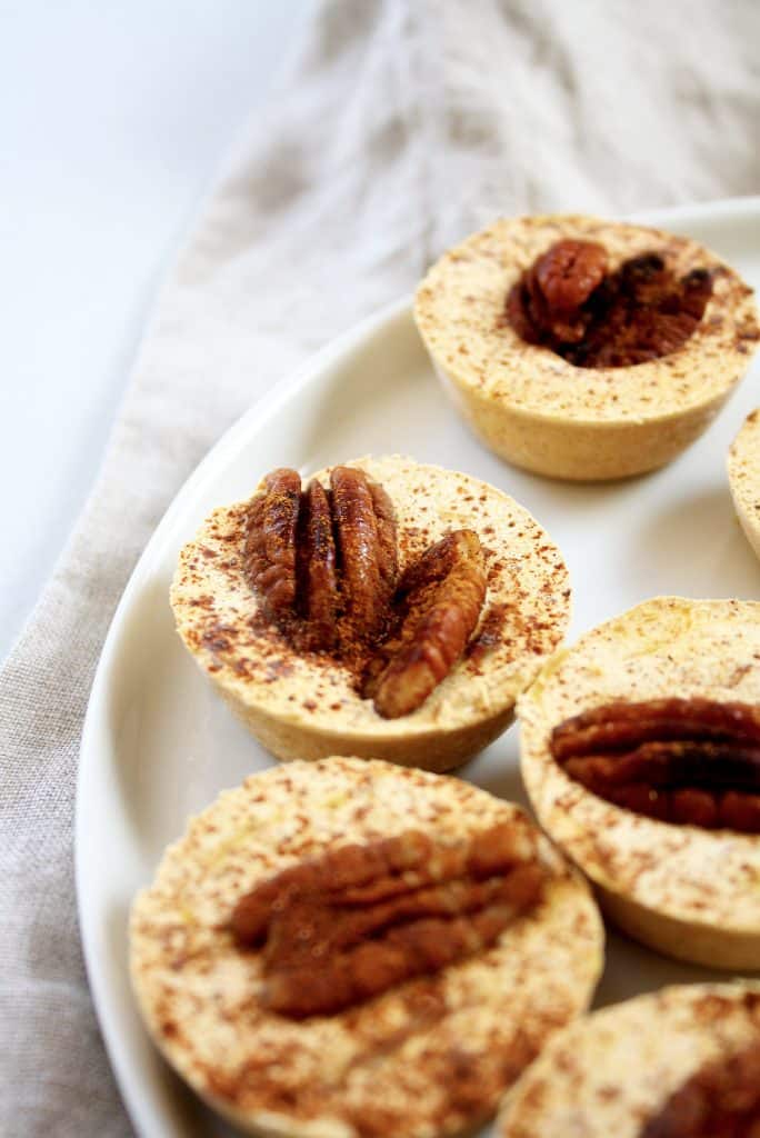 side-angle-shot-of-pumpkin-spice-fat-bombs-on-white-plate