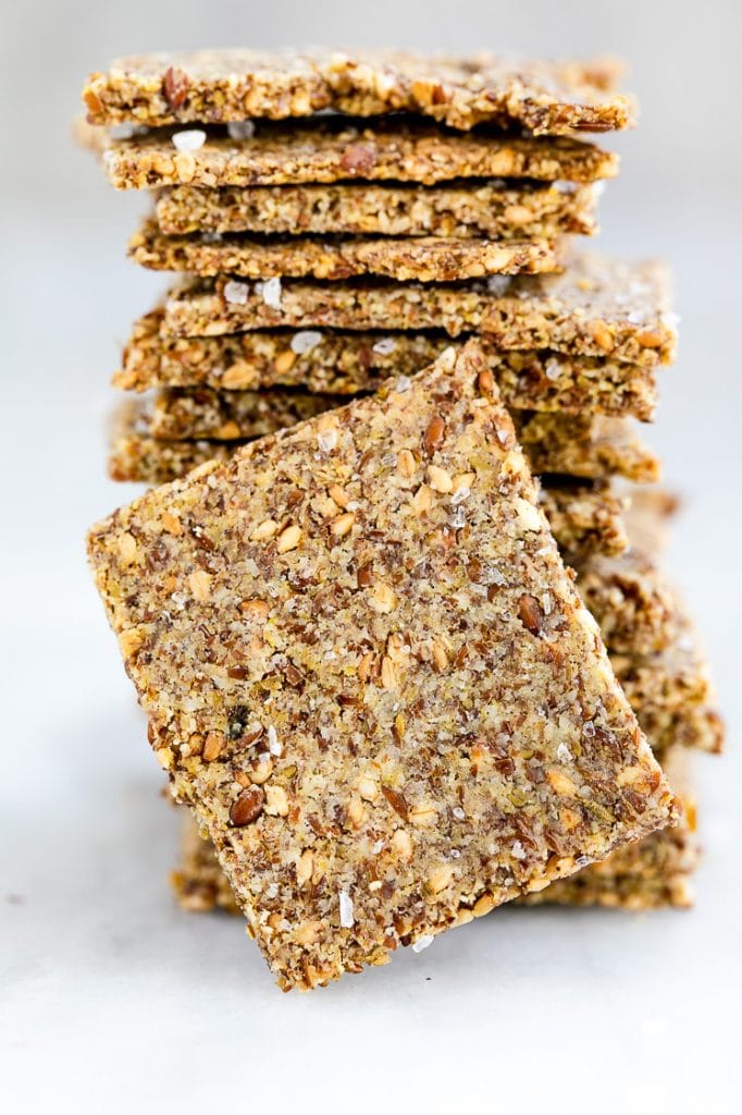 featured recipe shot - low carb cracker placed in front of a stack of more low carb crackers