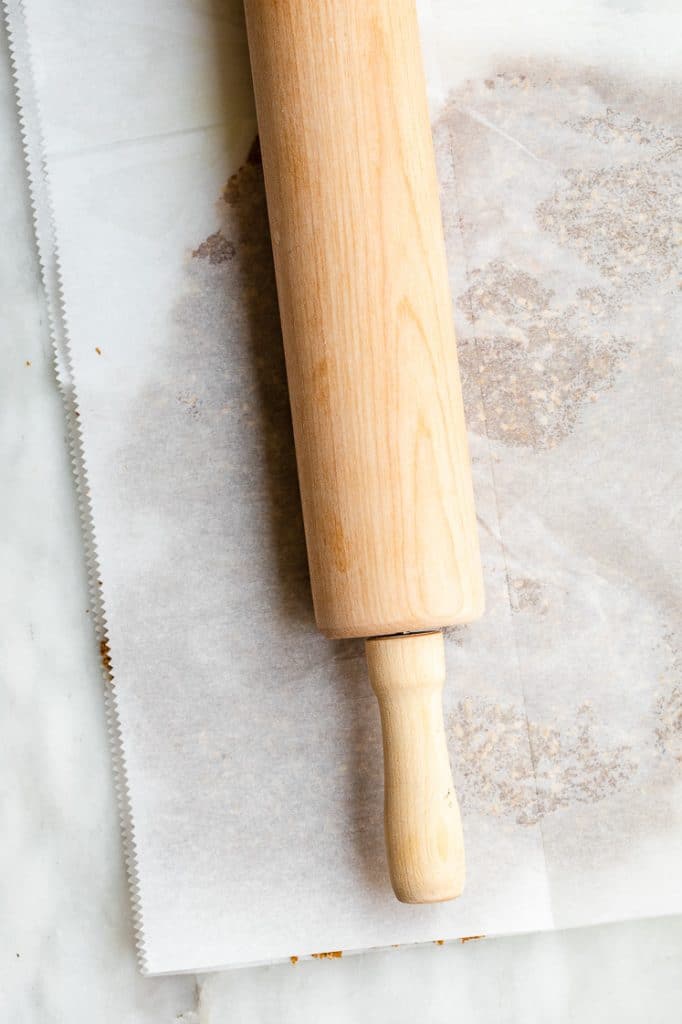 low carb crackers dough flattened using a wooden rolling pin