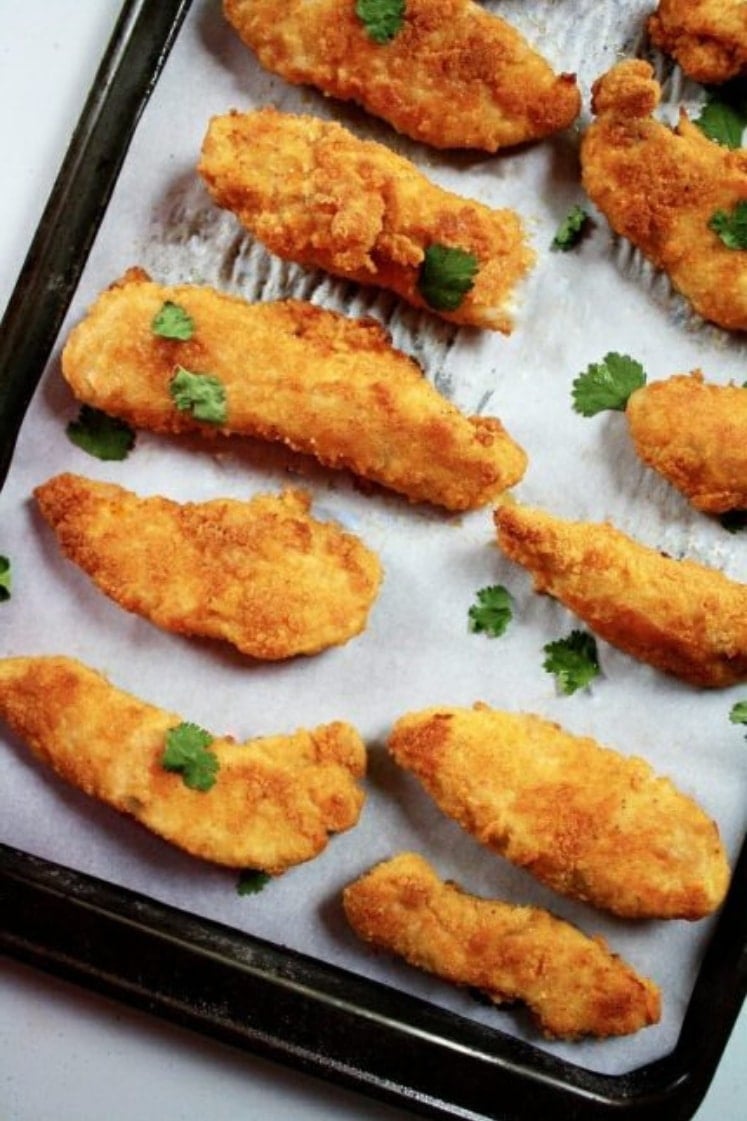 30-Minute Paleo Chicken Tenders on a baking sheet lined with parchment paper