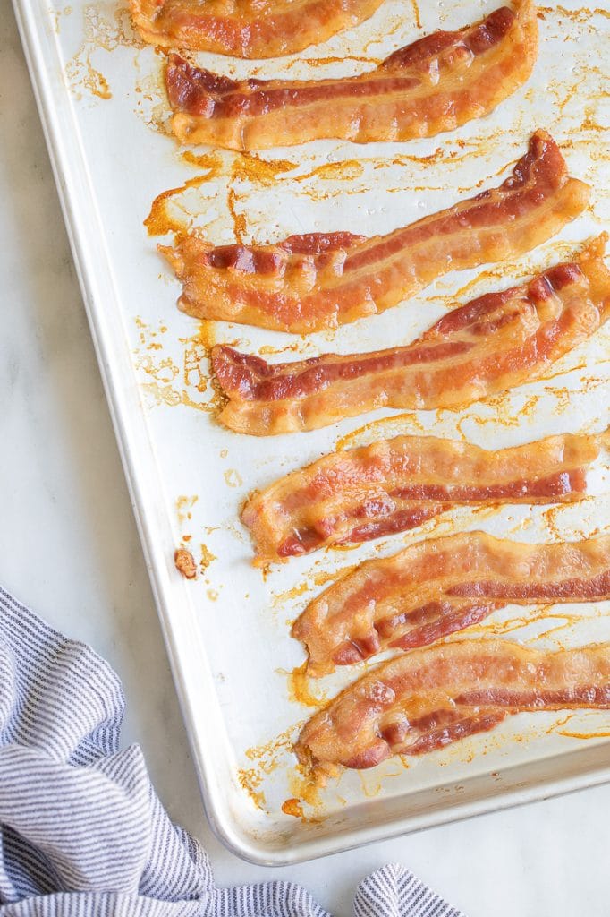 baked crispy slices bacon on a baking tray