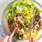 Big Mac salad being mixed in a bowl.