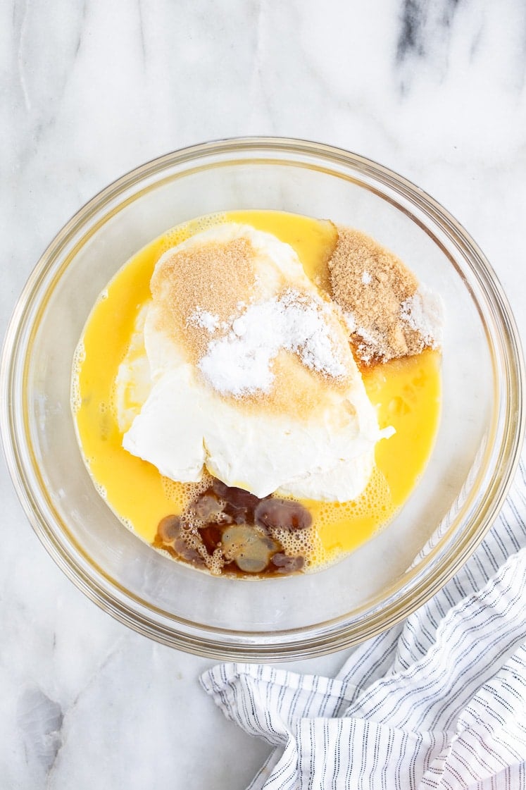 cream cheese, eggs, monk fruit sweetener, vanilla extract, cream of tartar, and baking soda in a bowl