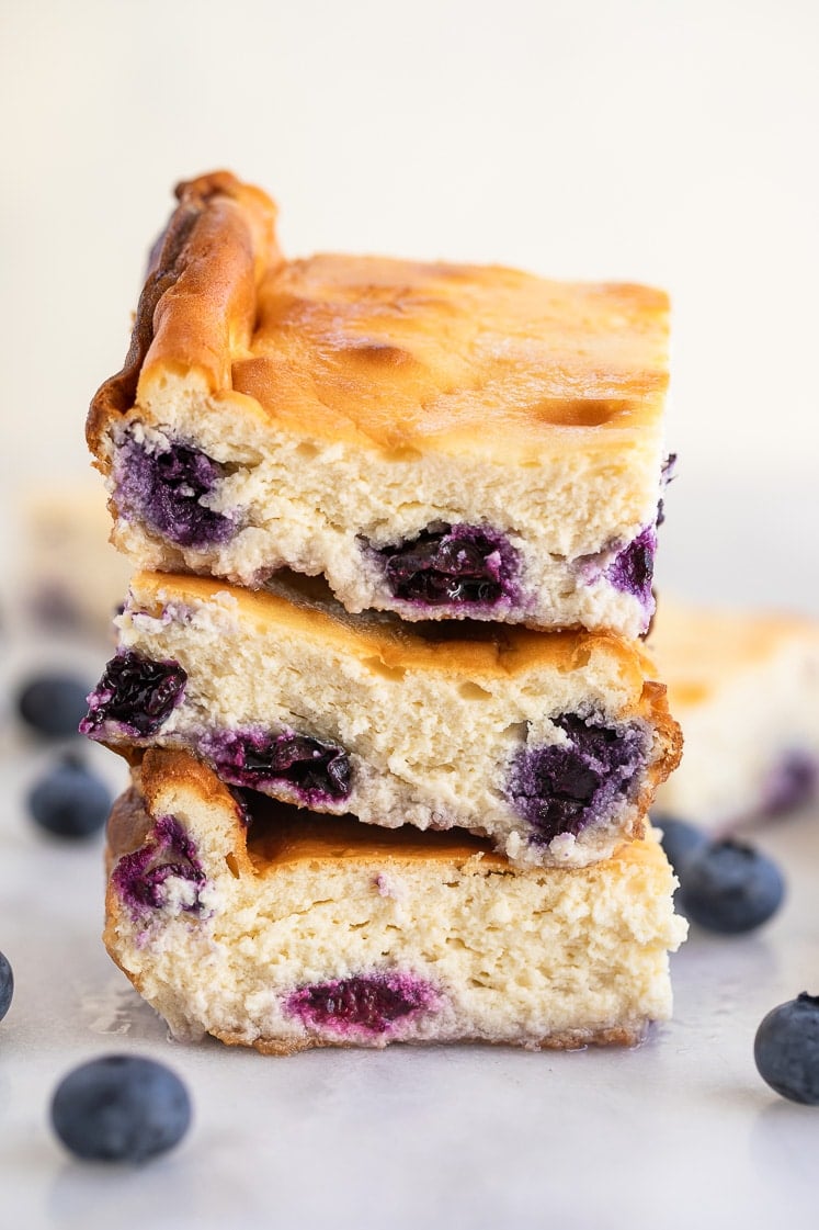 3 easy keto blueberry cheesecake bars stacked on top of each other