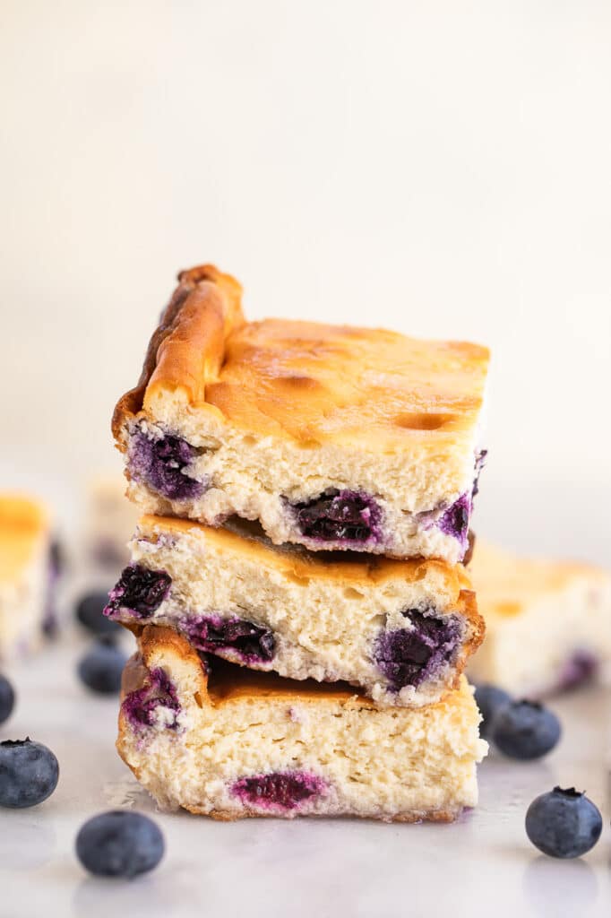 Low Carb Blueberry Cheesecake bars stacked on top of each other