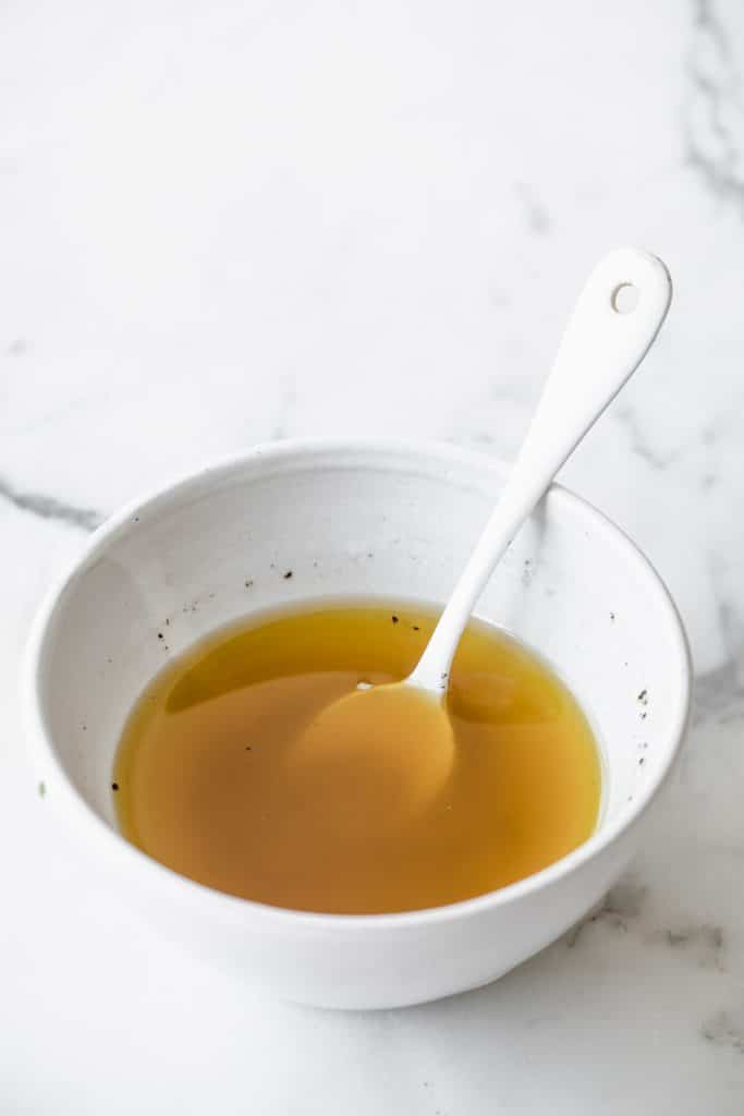 vinaigrette in a small bowl with a teaspoon