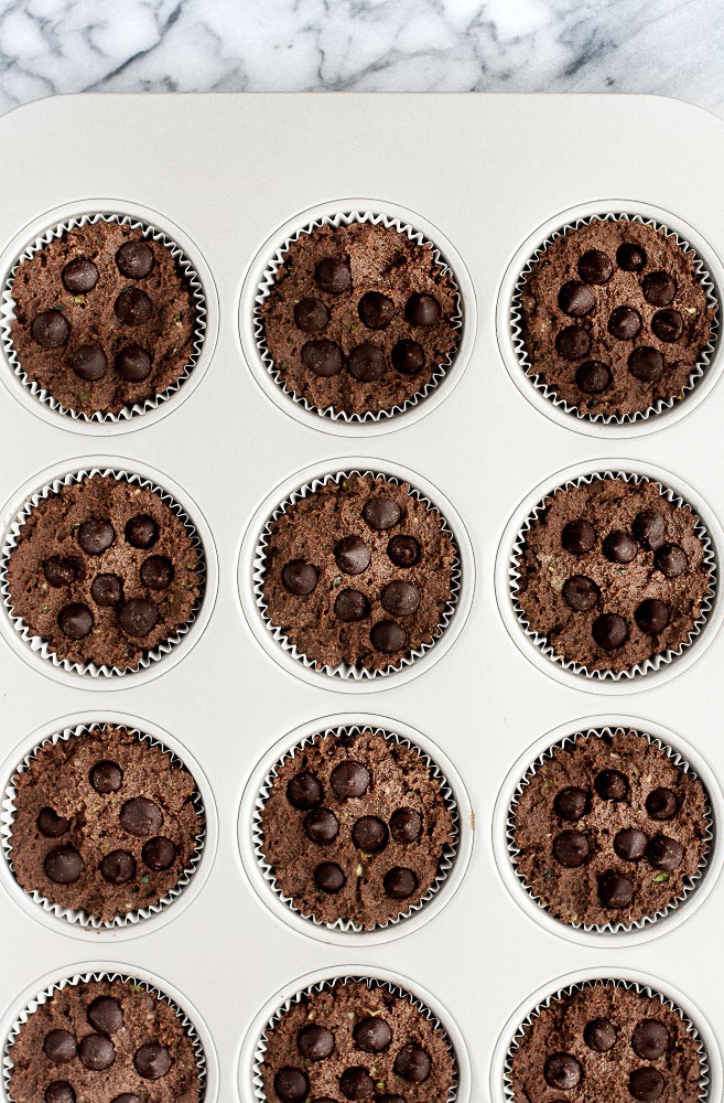 Low-Carb-Triple-Chocolate-Zucchini-Muffins-in-muffin-tin-with-chocolate-chips-before-baking