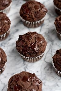 45-degree-angle-shot-on-marble-baking-board-of-Low-Carb-Triple-Chocolate-Zucchini-Muffins