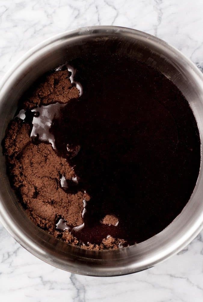 melted-chocolate-in-bowl-with-mixed-ingredients-for-Low-Carb-Triple-Chocolate-Zucchini-Muffins