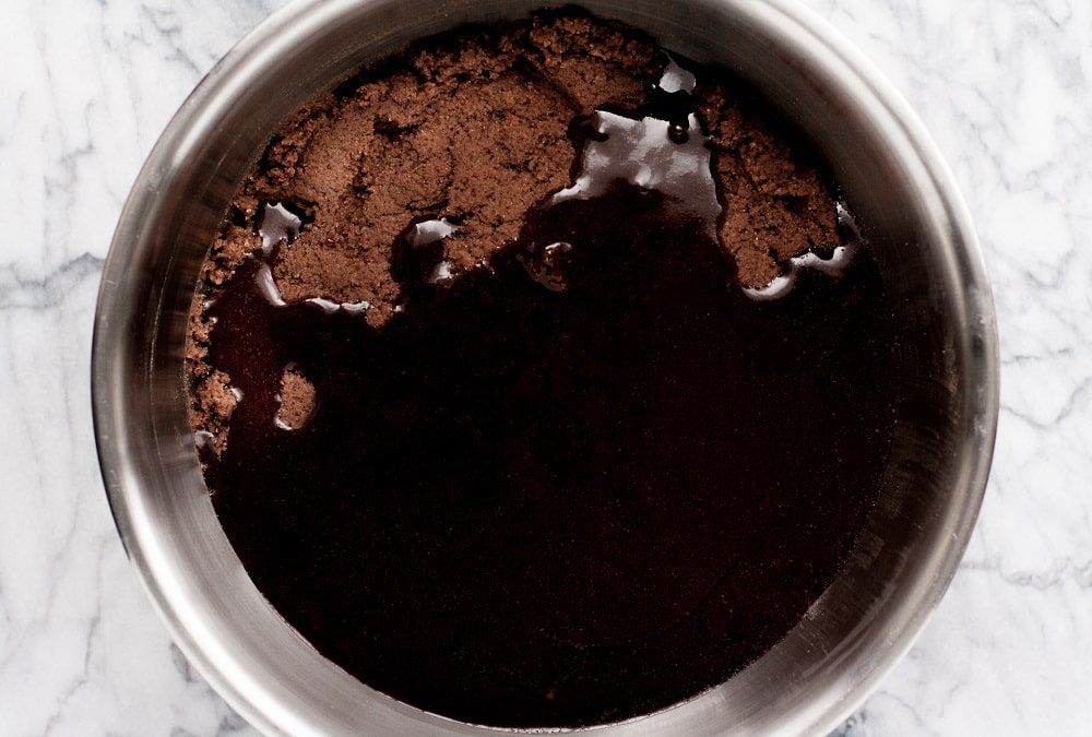 melted-chocolate-in-bowl-with-mixed-ingredients-for-Low-Carb-Triple-Chocolate-Zucchini-Muffins