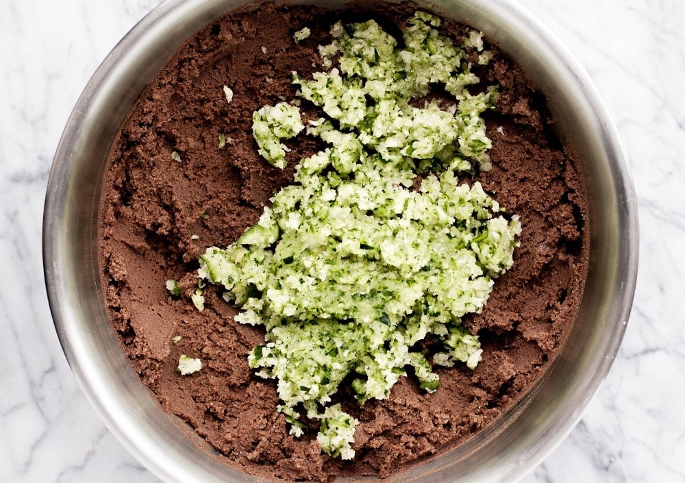 grated-zucchini-in-bowl-with-mixed-ingredients-for-Low-Carb-Triple-Chocolate-Zucchini-Muffins