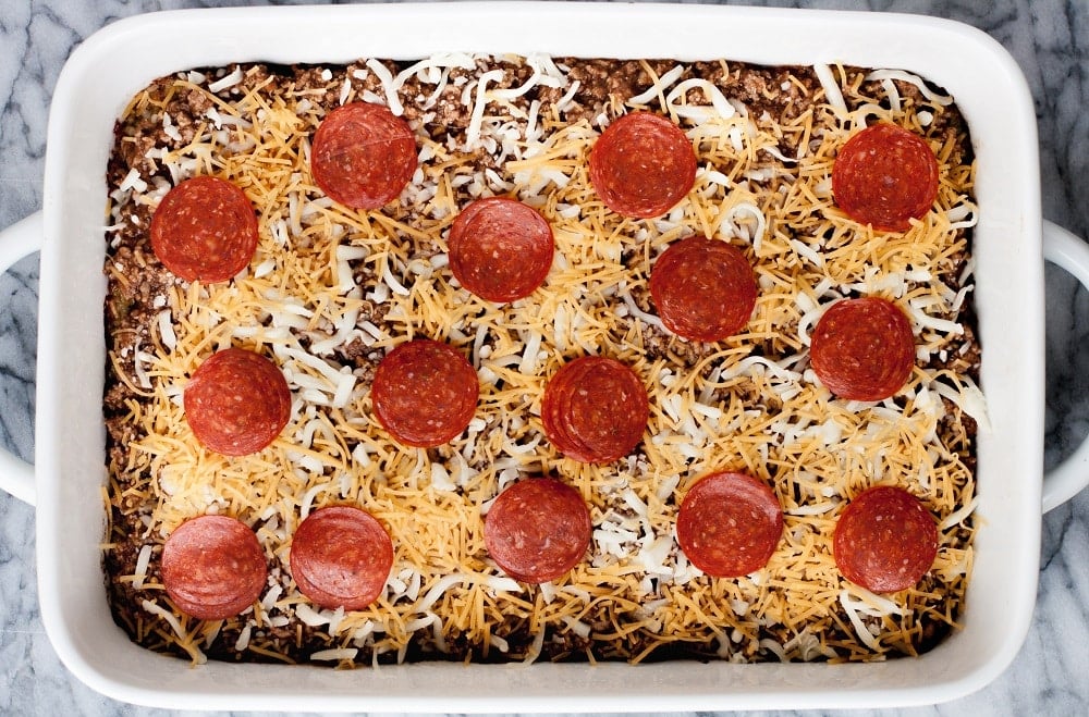 ingredients-in-ceramic-white-casserole-pan-on-marble-board-for-Low-Carb-Zucchini-Pizza-Casserole