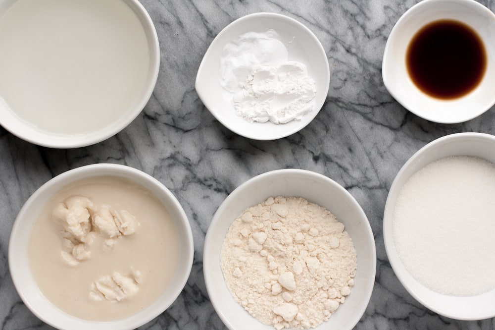 ingredients-for-Low-Carb-Coconut-Blondies-in-white-ceramic-bowls-on-marble-board