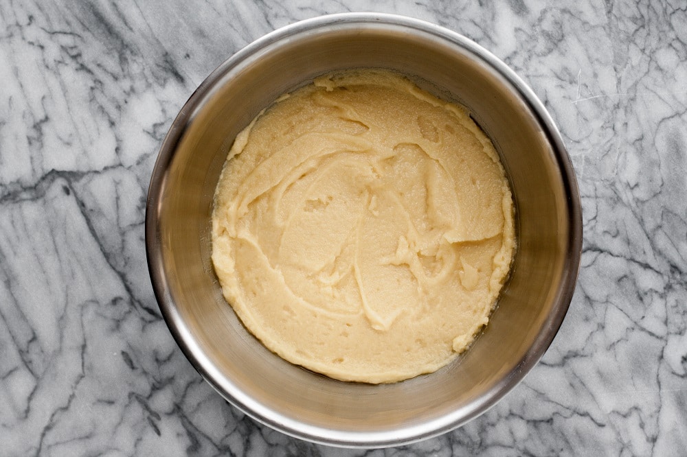 all-ingredients-for-Low-Carb-Coconut-Blondies-mixed-in-stainless-steel-mixing-bowl-on-marble-board