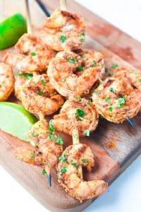 chili lime shrimp skewers on a cheeseboard
