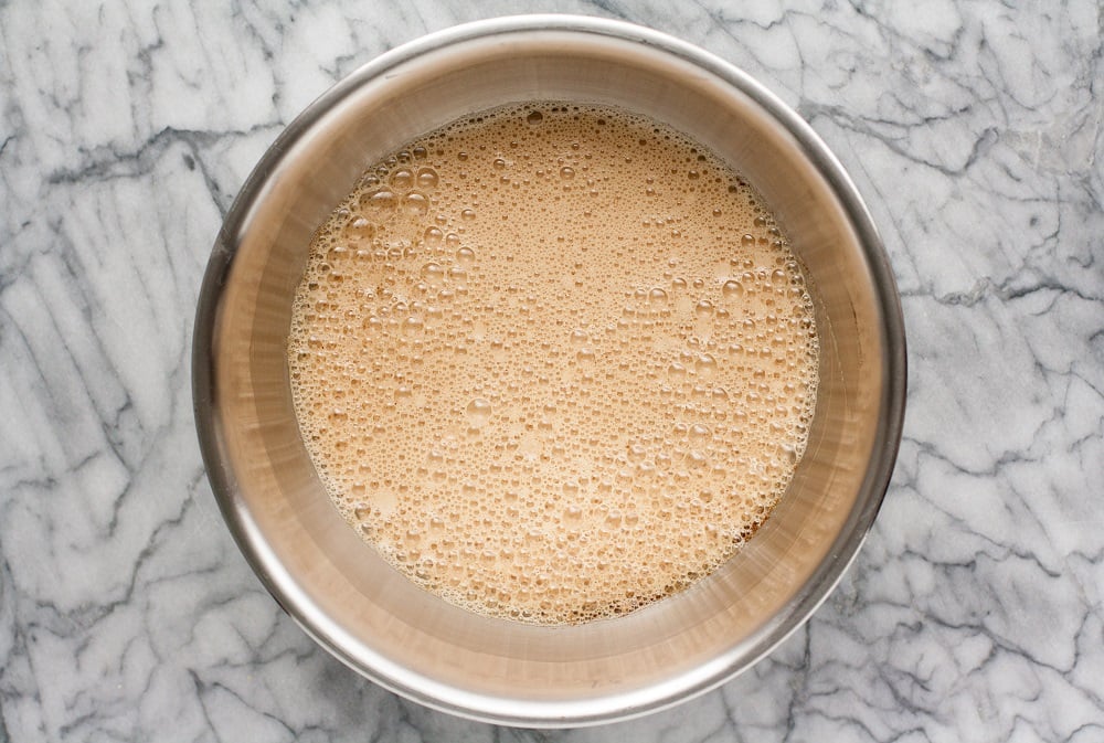 overhead-shot-of-mixture-in-stainless-steel-bowl-for-Cream-Cheese-Pumpkin-Muffins-on-marble-board