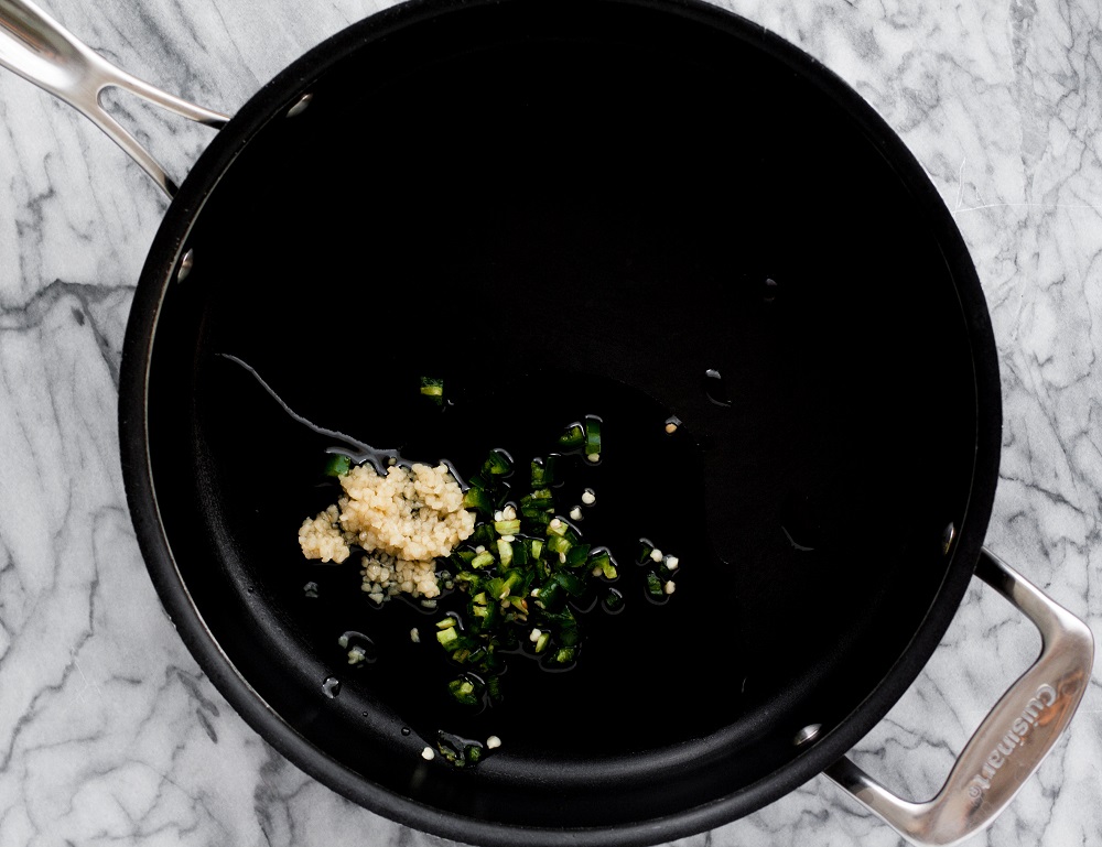 chopped-jalapenos-and-garlic-in-black-pan-on-marble-board