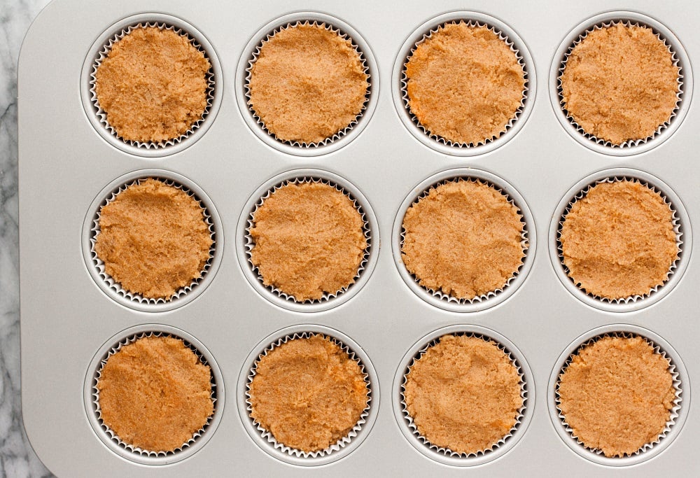 overhead-shot-of-Cream-Cheese-Pumpkin-Muffins-dough-in-muffin-tin-on-marble-board