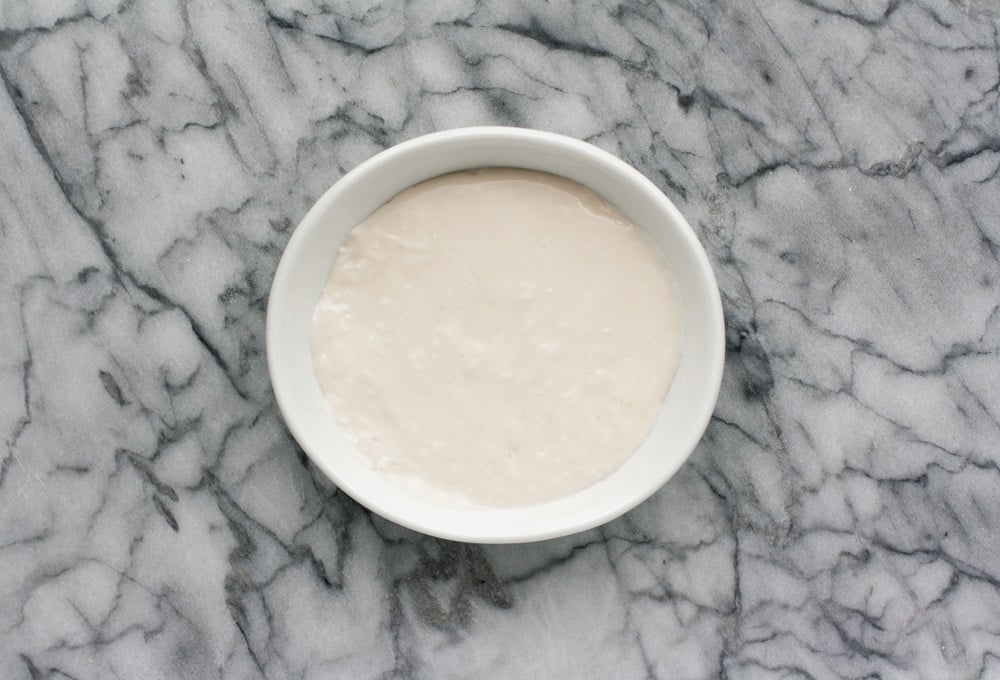 overhead-shot-of-cream-cheese-frosting-for-Cream-Cheese-Pumpkin-Muffins-on-marble-board