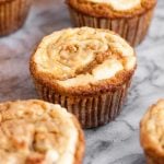 side-angle-shot-of-Cream-Cheese-Pumpkin-Muffins-on-marble-board