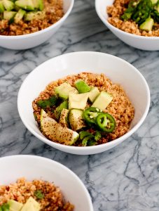 side-view-mexican-cauliflower-rice-in-white-bowls-on-marble-board