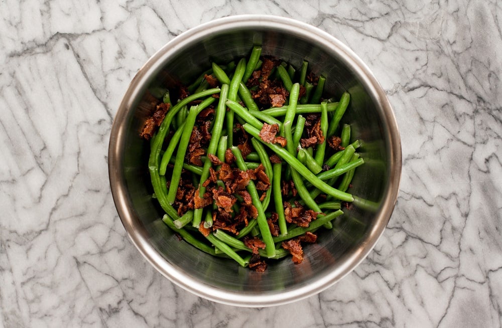 mixture-of-green-beans-and-crumbled-bacon-on-marble-board-for-bacon-green-bean-casserole
