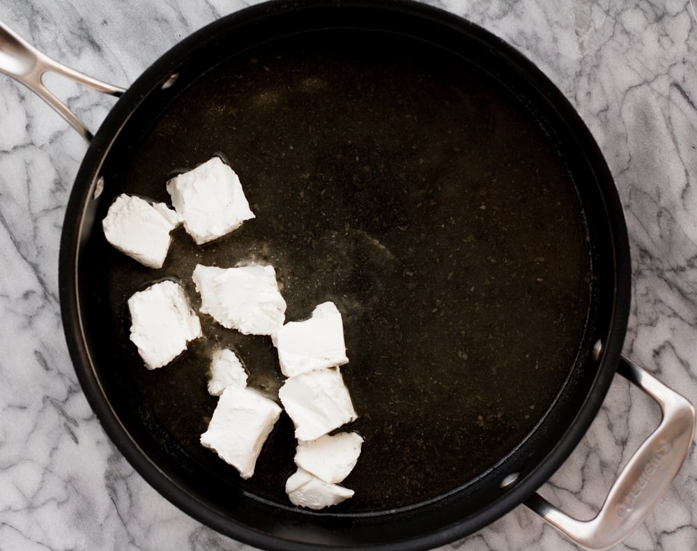 black-pot-with-cubed-cream-cheese-on-marble-board-for-bacon-green-bean-casserole