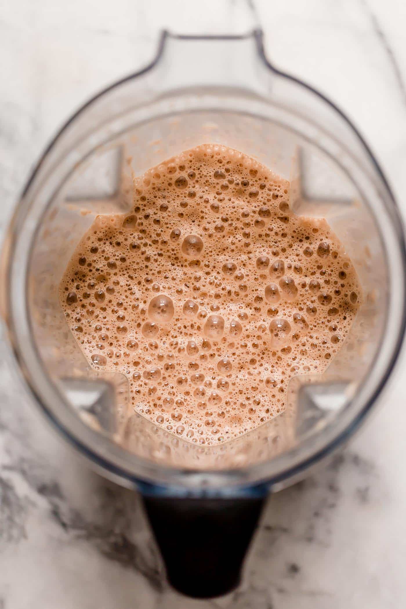 overhead shot of frothy and keto-friendly peppermint mocha pulsed in a blender