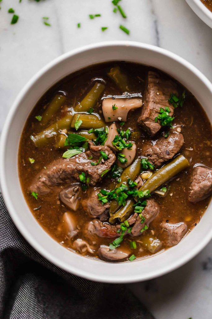 overhead shot of instant pot beef stew in a ceramic bowl