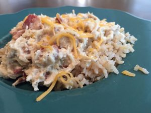 instant pot creamy bacon ranch crack chicken on a teal plate