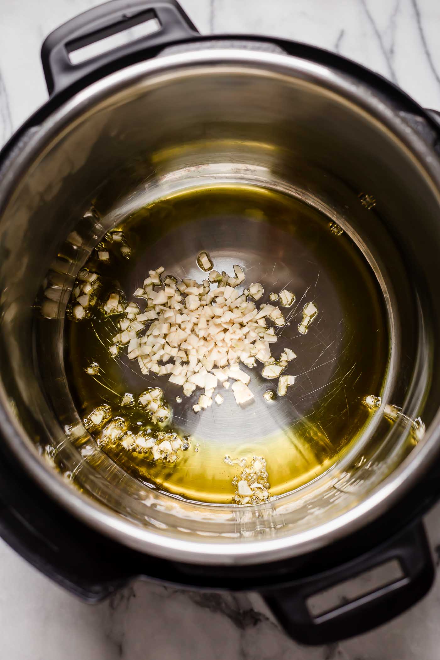 Insta pot with avocado oil and minced garlic