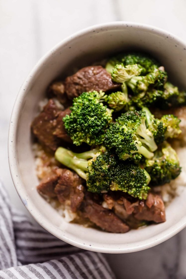 Instant Pot Beef Broccoli with Rice in a ceramic bowl on top of a marble counter