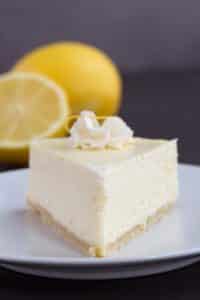 keto instant pot lemon cheesecake slice on a plate with lemons in the background