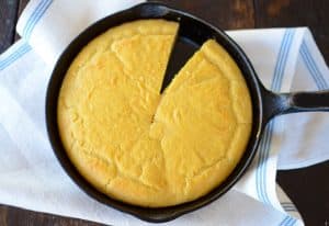 keto corn bread in a cast iron skillet on top of a table napkin