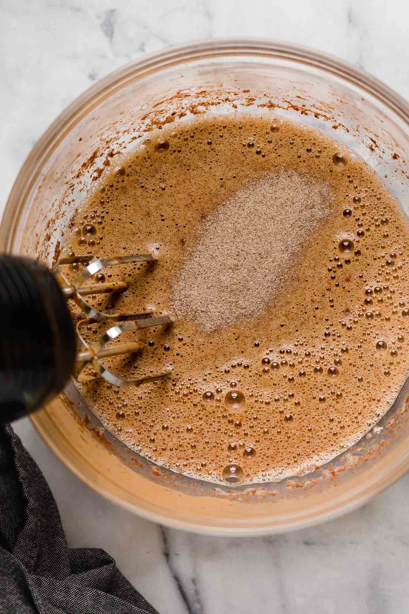 egg mixture and spices mixed using an electric mixer turned on to medium-high speed