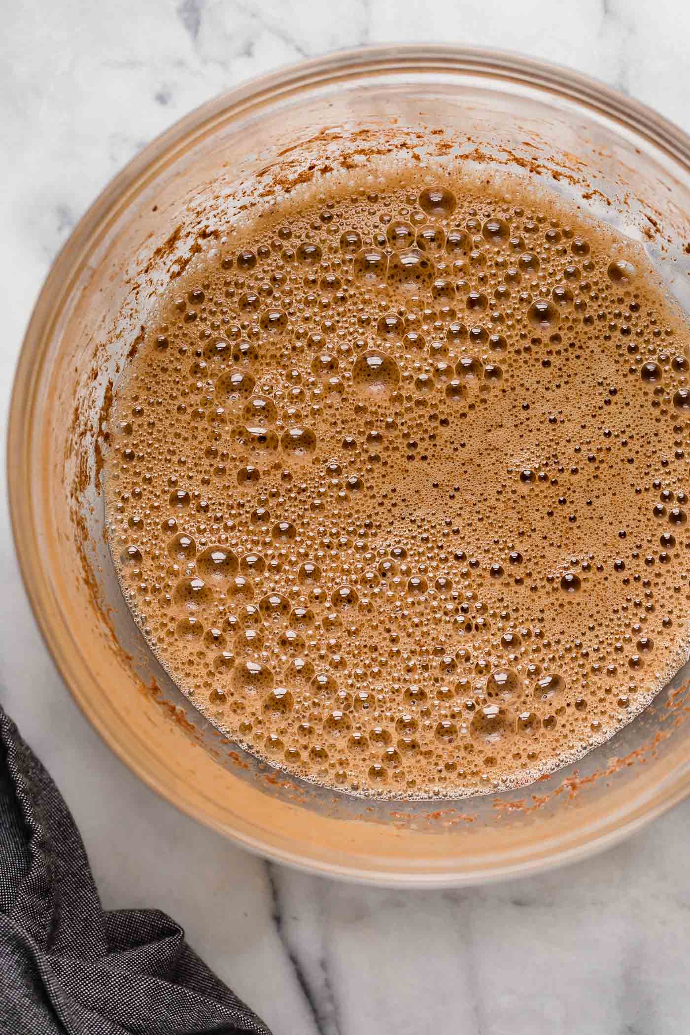 flourless pancake batter in a large mixing bowl on top of a marble counter