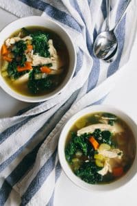 instant pot chicken soup with kale served in bowls with beside spoons