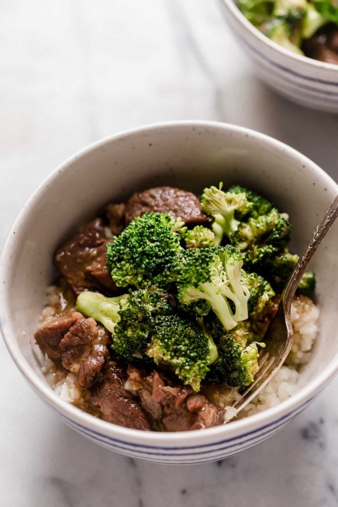 instant pot beef broccoli in a bowl on top of a marble counter