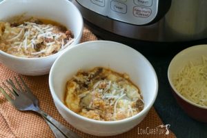 instant pot no noodle lasagna in bowls beside forks and an instant pot