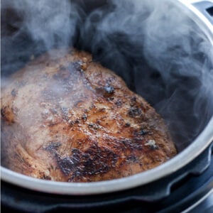 jamaican jerk pork roast in an instant pot steam rising