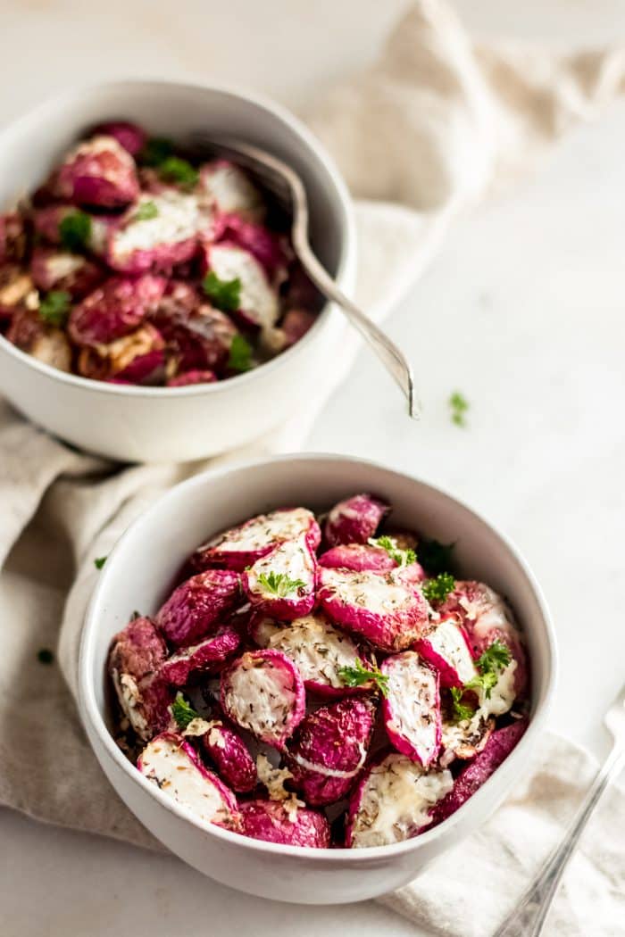 two servings of keto roasted radishes in white ceramic bowls