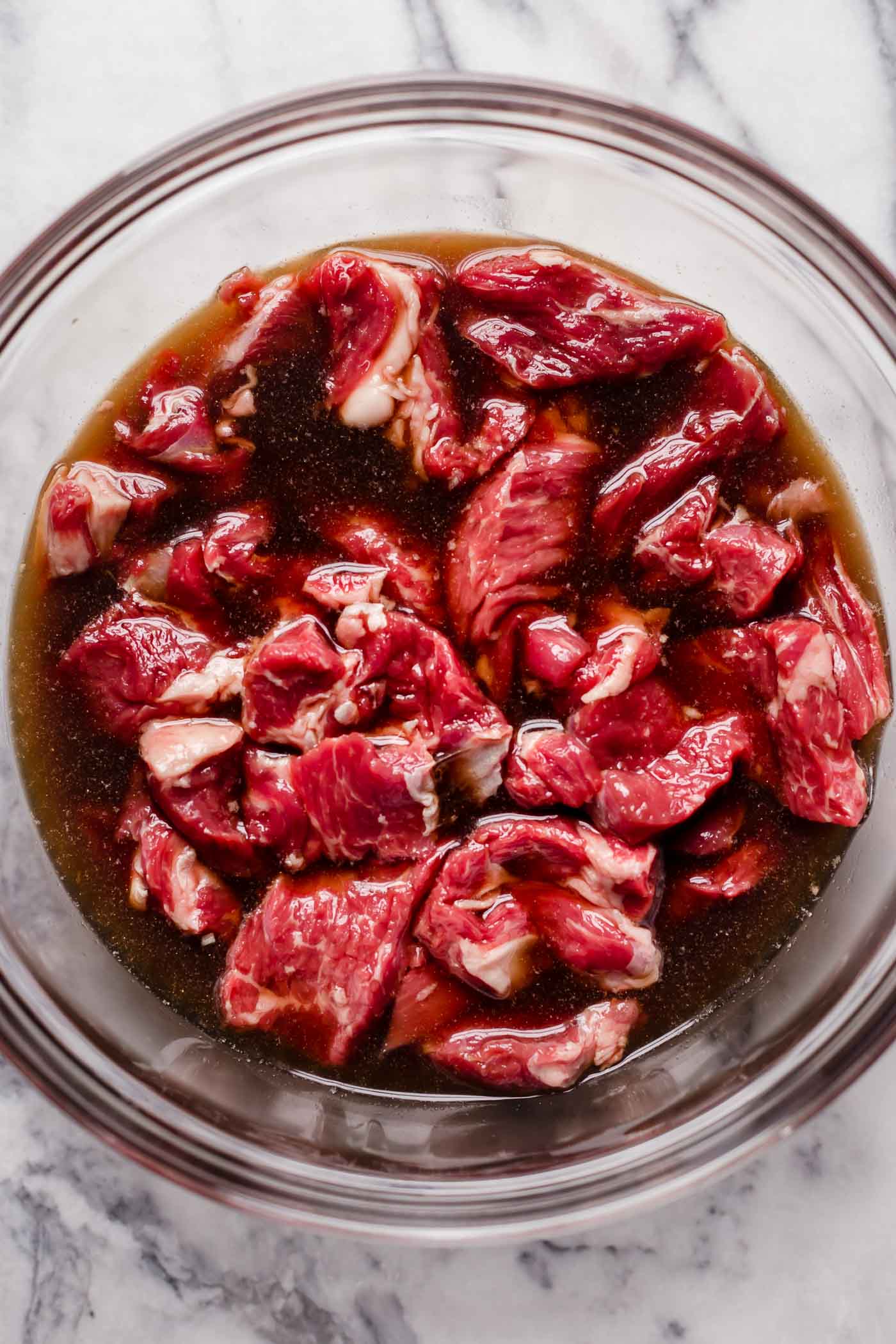 mix sliced chuck roast into beef broth, liquid aminos, ground ginger and monk fruit sweetener mixture