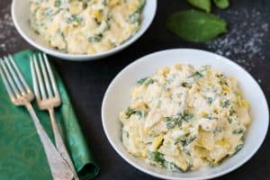 instant pot spinach artichoke chicken in plates beside forks