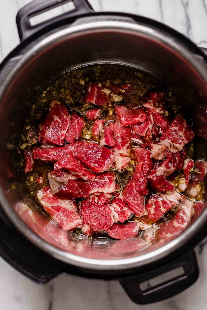 sliced chuck roast sauteed with minced garlic in an instant pot
