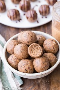 Bowl of Nutty coconut fat bombs with one half-eaten
