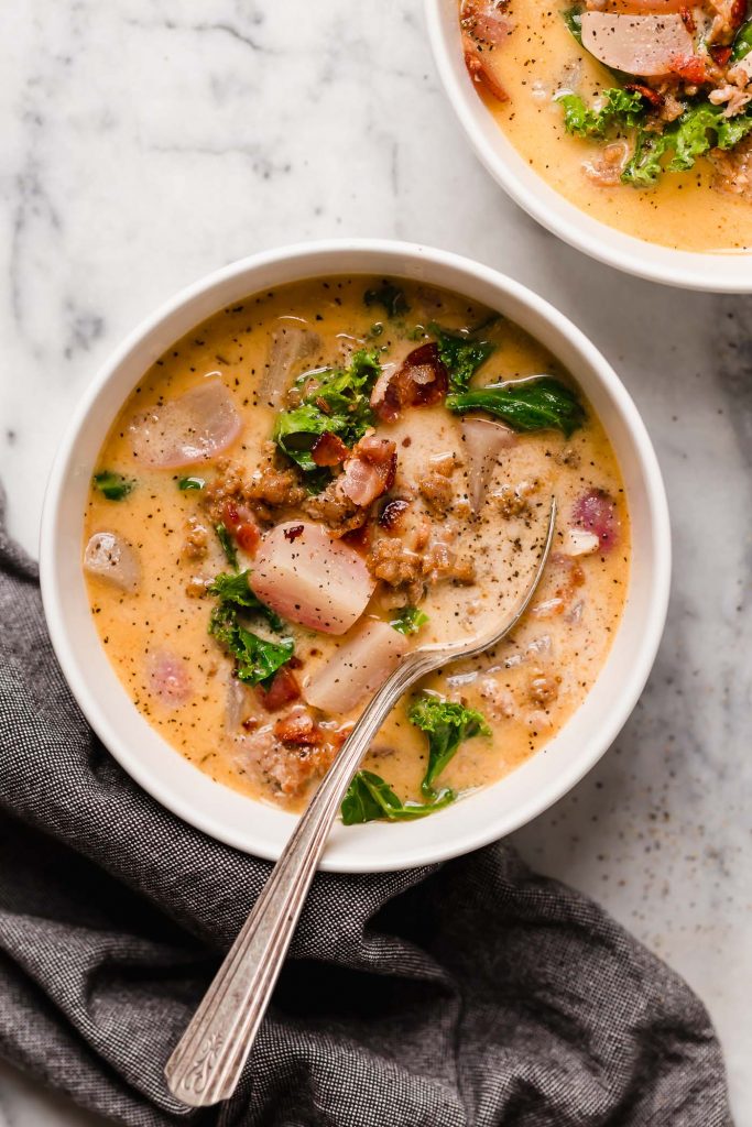 overhead shot of a bowl of keto zuppa toscana with a spoon