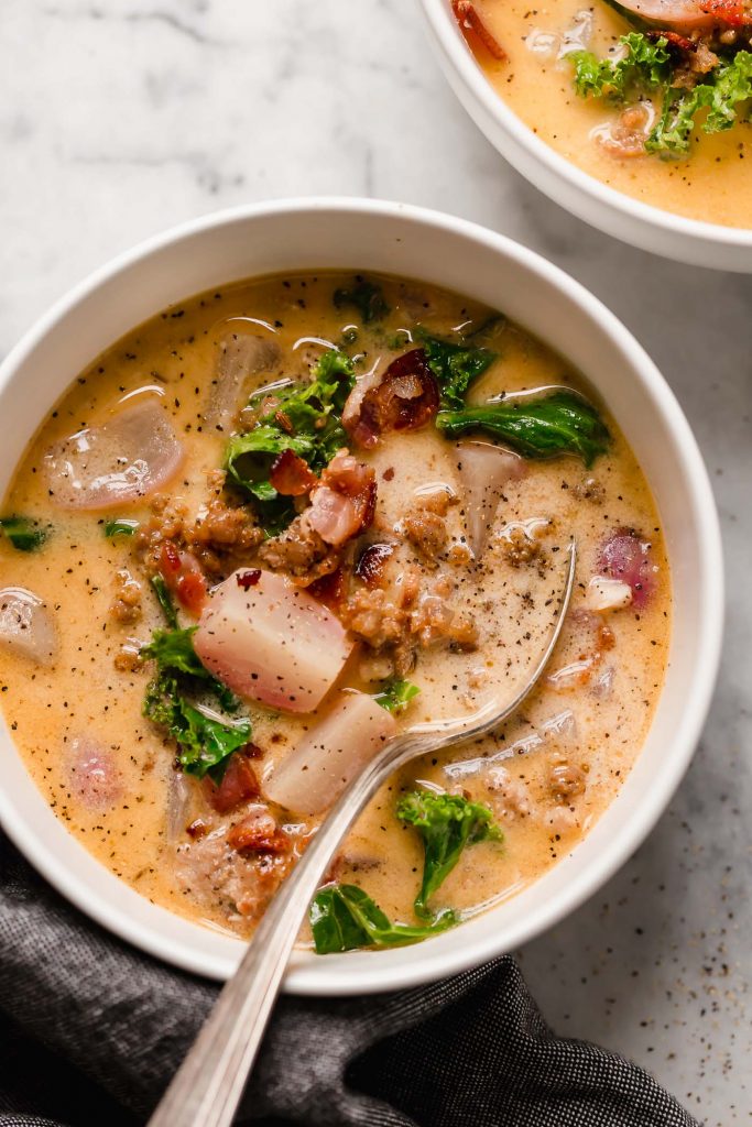 close up overhead shot of a bowl of keto zuppa toscana with a spoon 