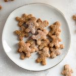 Hero shot a bunch of keto gingerbread cookies on a ceramic plate