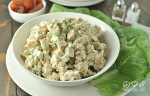 Bowl of Dill Chicken Salad on a plate with lettuce leaves